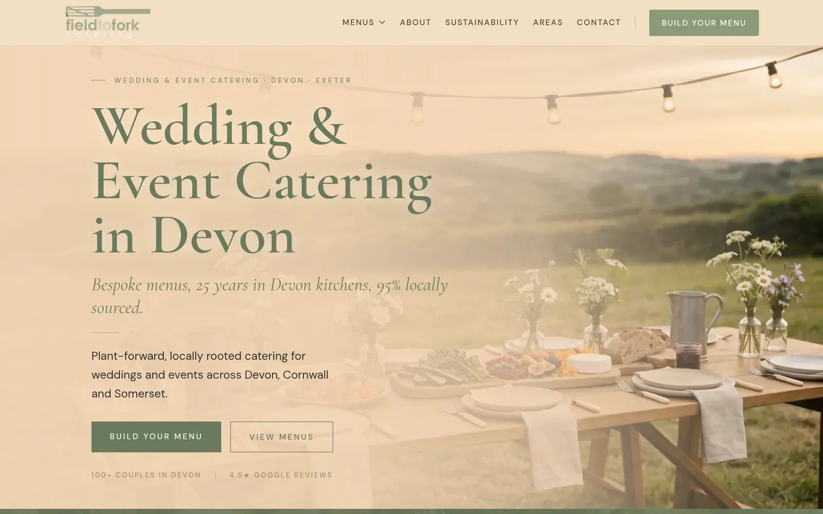 The Field to Fork Catering homepage: a long table laid in a Devon field at dusk under festoon lights, with the headline over it.